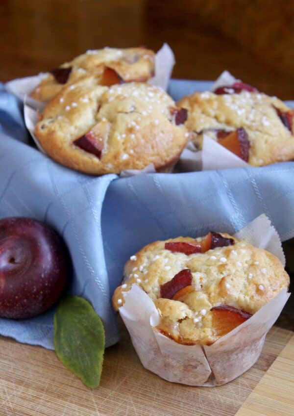 perfect plum muffins in a basket with a plum 
