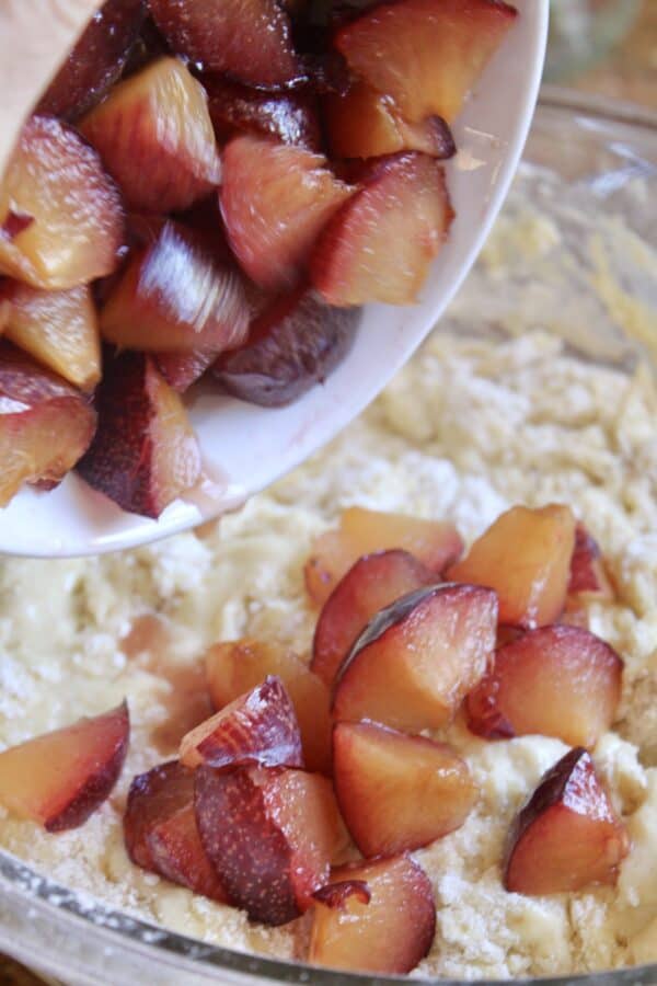 adding plums to the muffin mixture