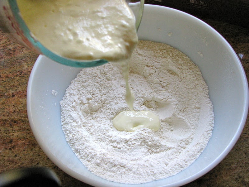 adding yogurt mixture to flour