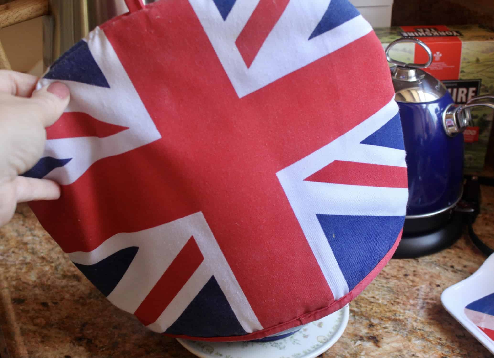 putting Union Jack tea cosy on teapot