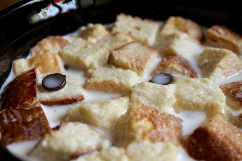 Chocolate bread and butter pudding soaking before baking