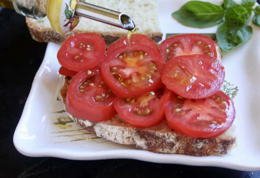 drizzling oil on tomatoes