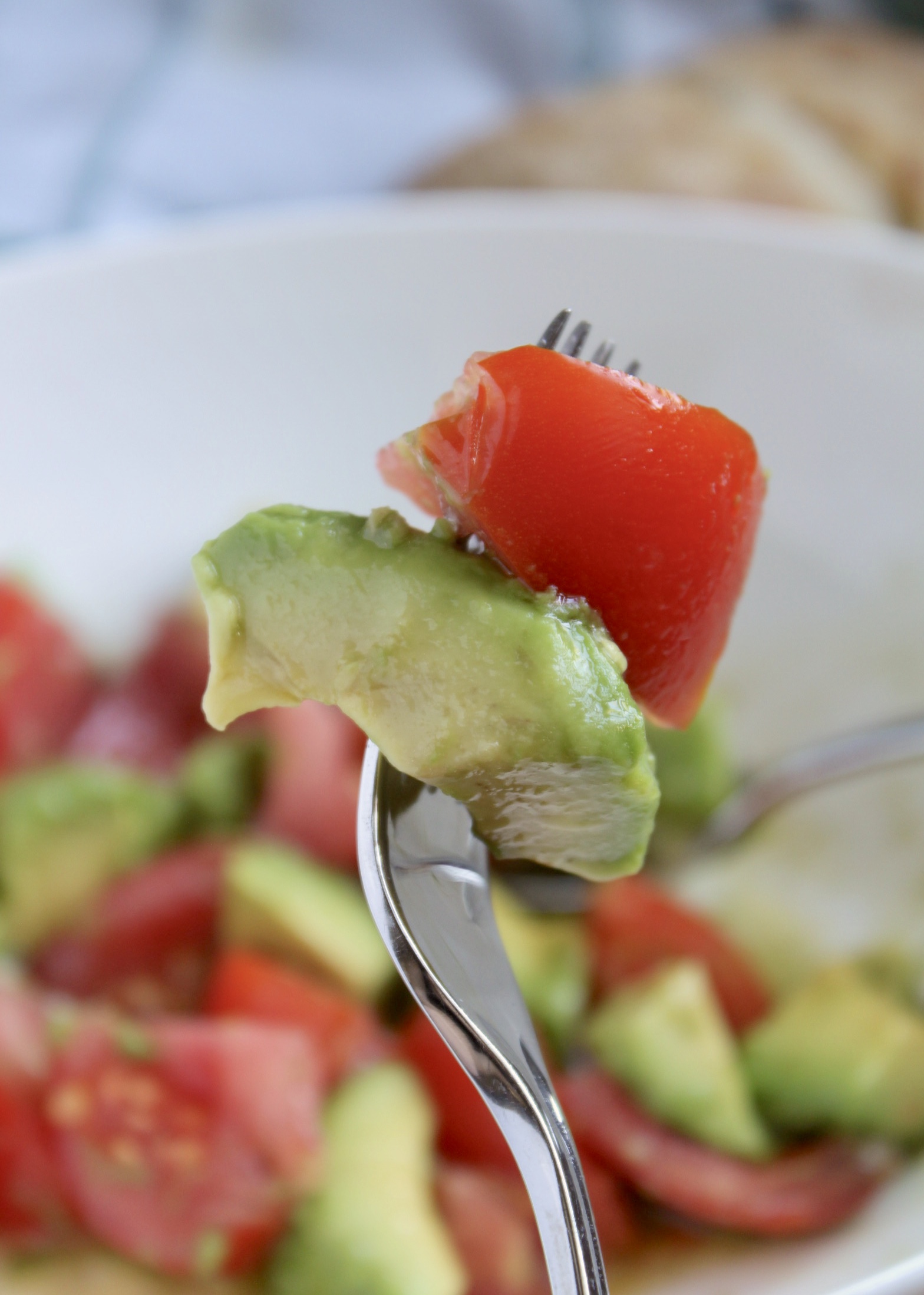 tomato and avocado slices on a fork