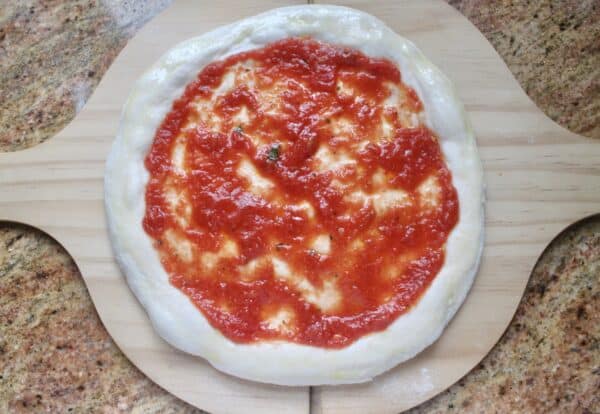 Homemade pizza dough on a peel