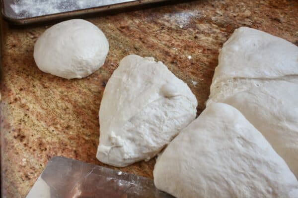 cutting homemade pizza dough 