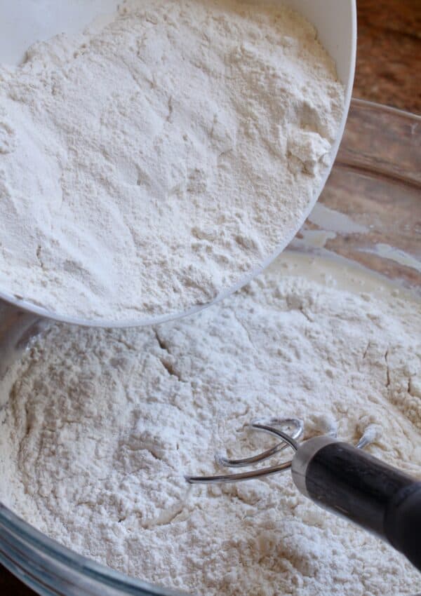 adding more flour for homemade pizza dough
