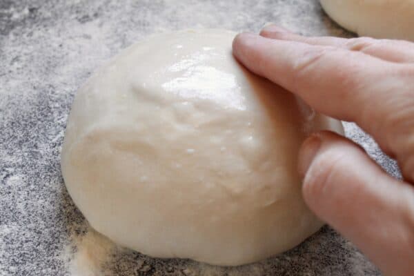 oiling a homemade pizza dough ball