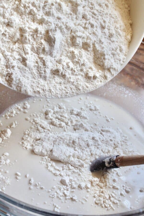 adding flour to mixture with poolish