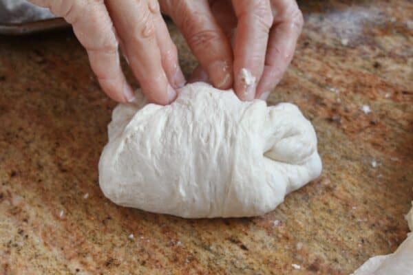 shaping a homemade pizza dough ball