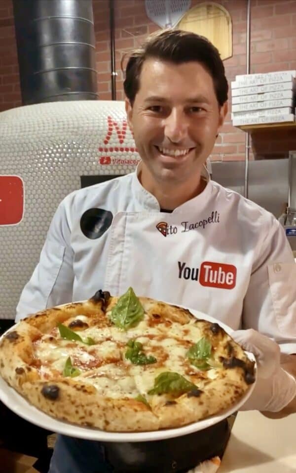 vito iacopelli holding a pizza