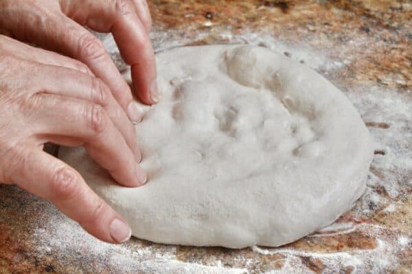 shaping homemade pizza dough