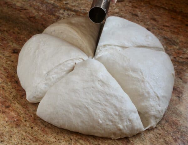 cutting homemade pizza dough 