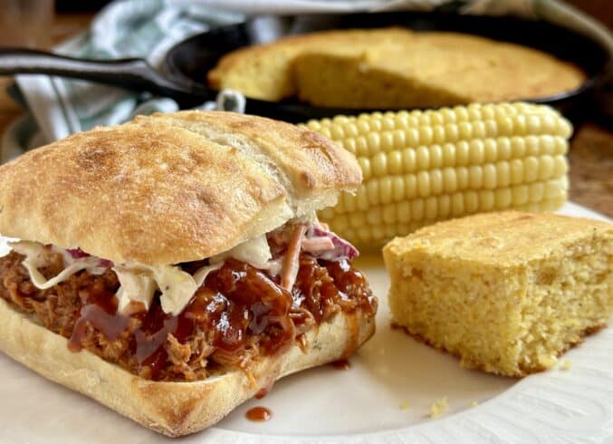 pulled pork sandwich with cole slaw and cornbread