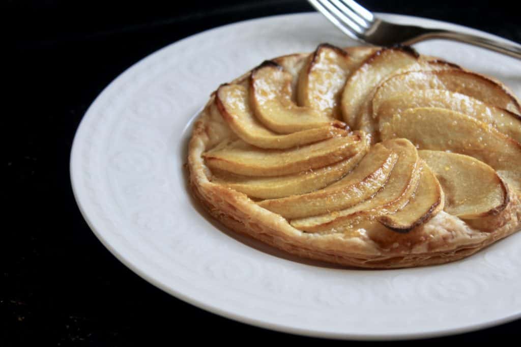 apple pastry on a white plate with a fork