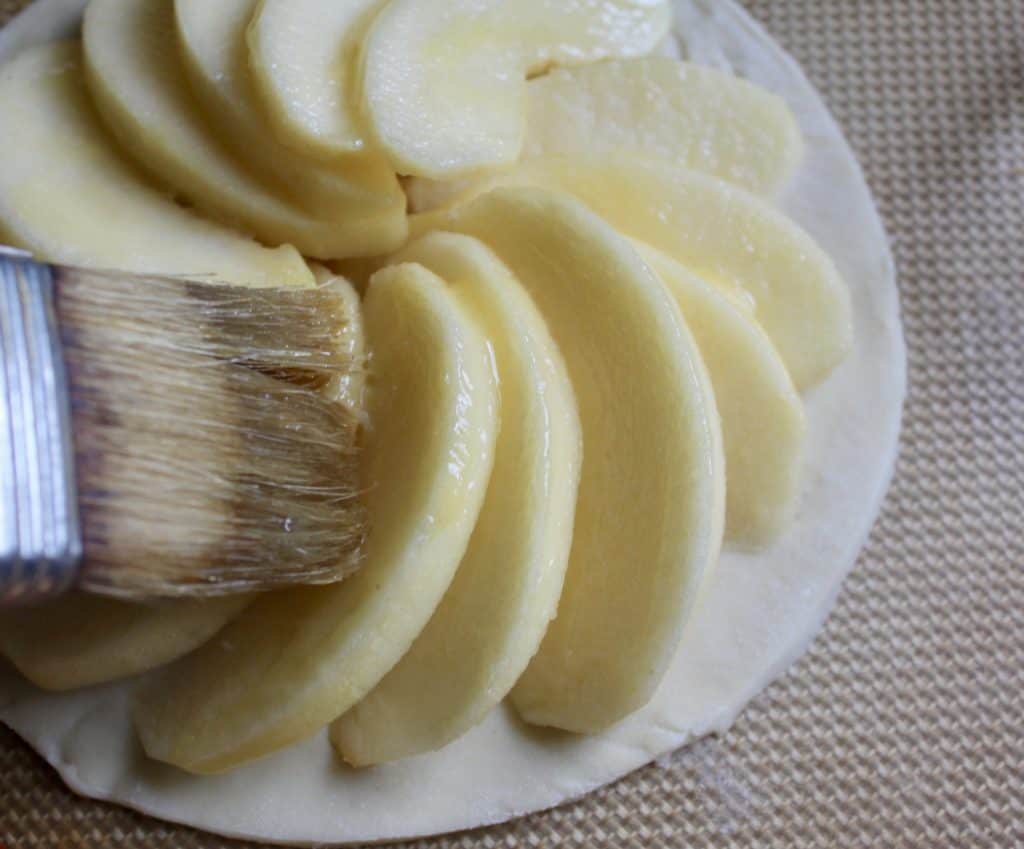 brushing apples with butter.