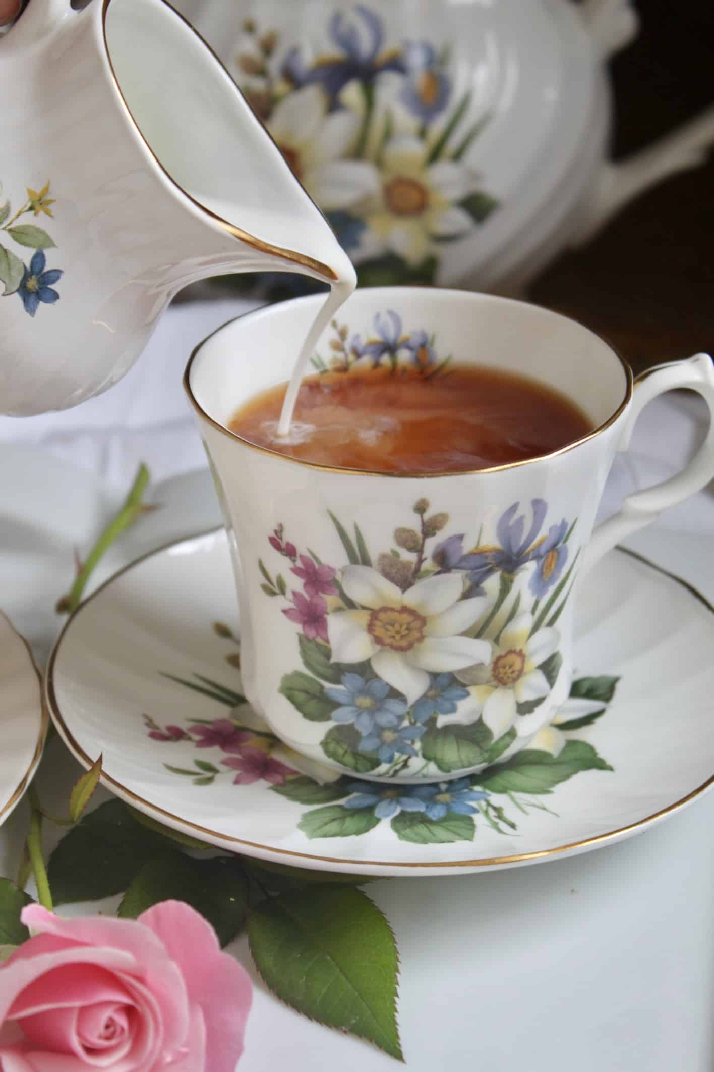 pouring milk into teacup 