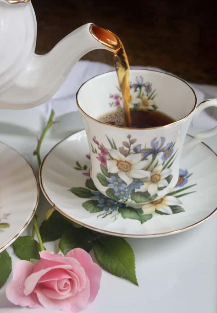 Pouring tea into a teacup