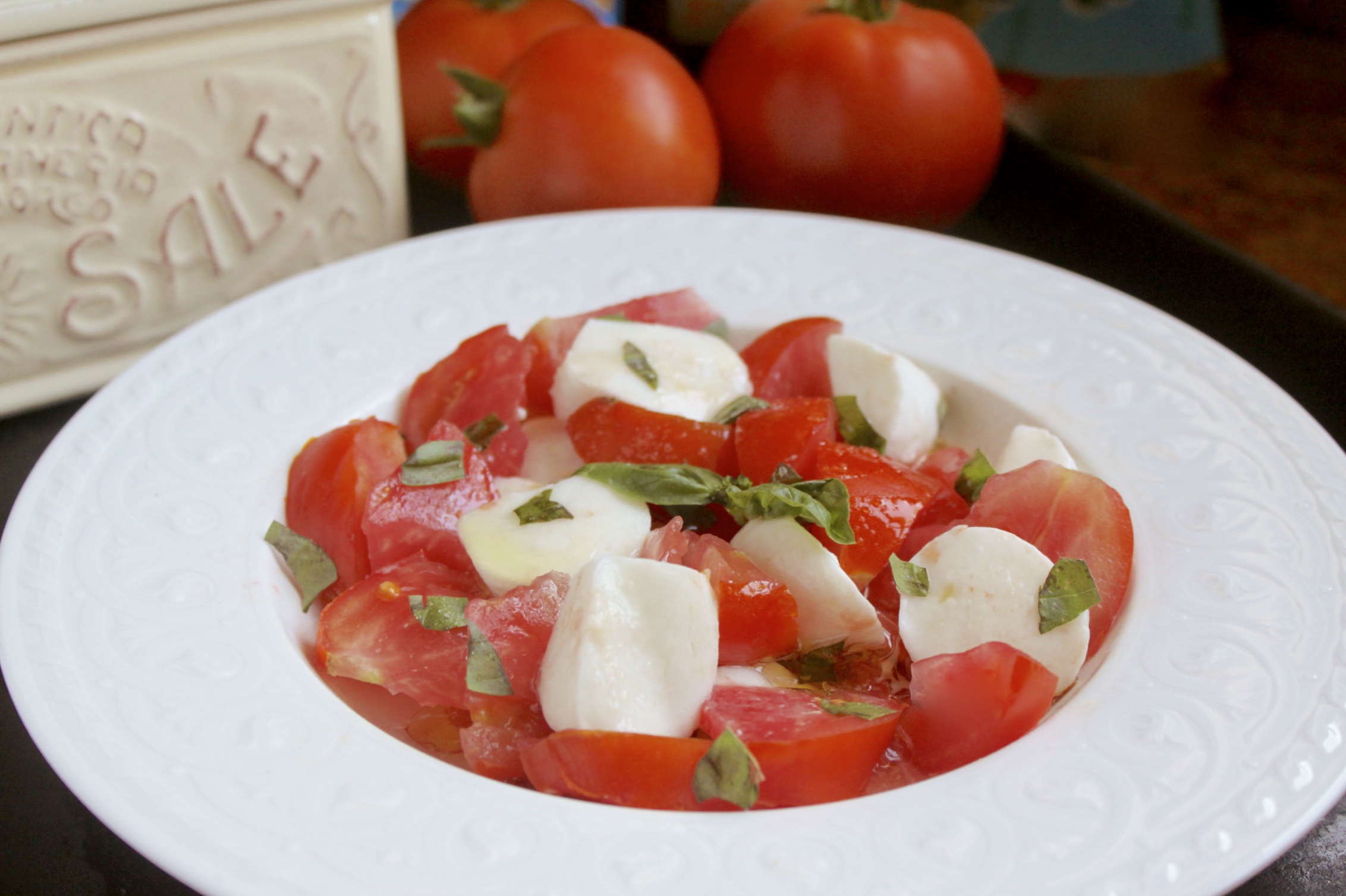 making mozzarella and tomato caprese salad