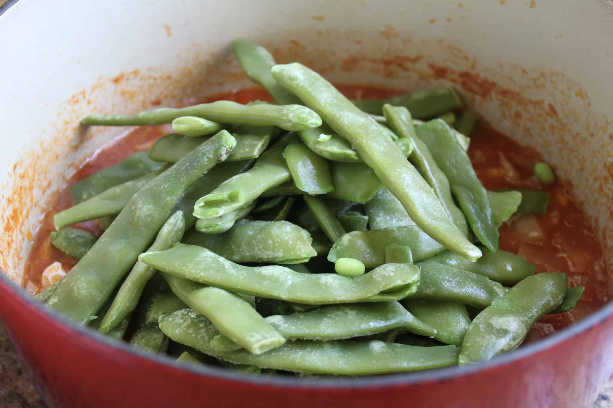 adding the beans to the pot