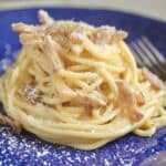 spaghetti alla carbonara on a blue plate