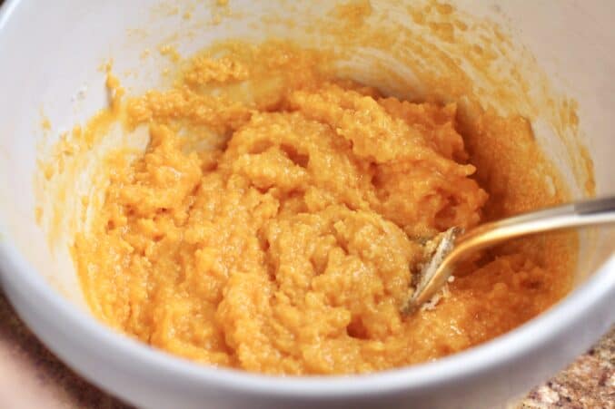 Beating the egg yolks and stirring in the cheese