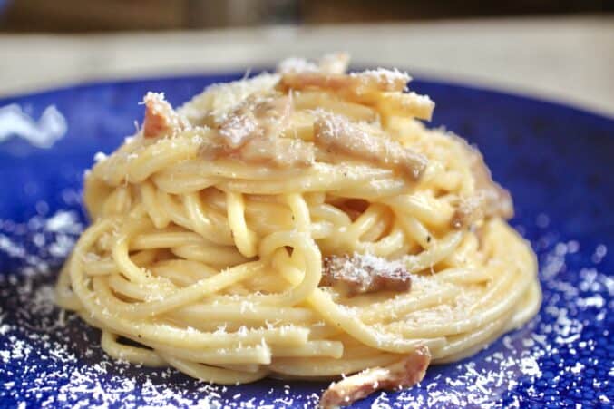 pasta carbonara on a blue plate