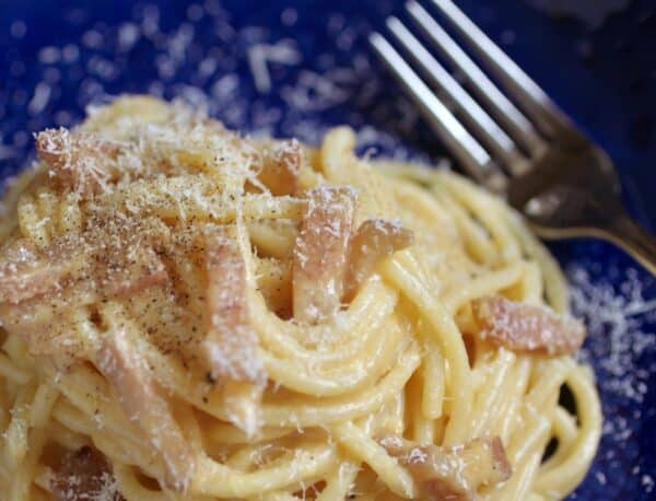 fork on a plate with pasta carbonara