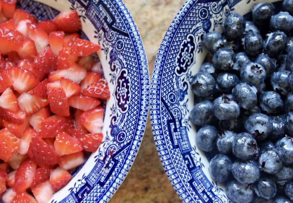 strawberries and blueberries in bowls