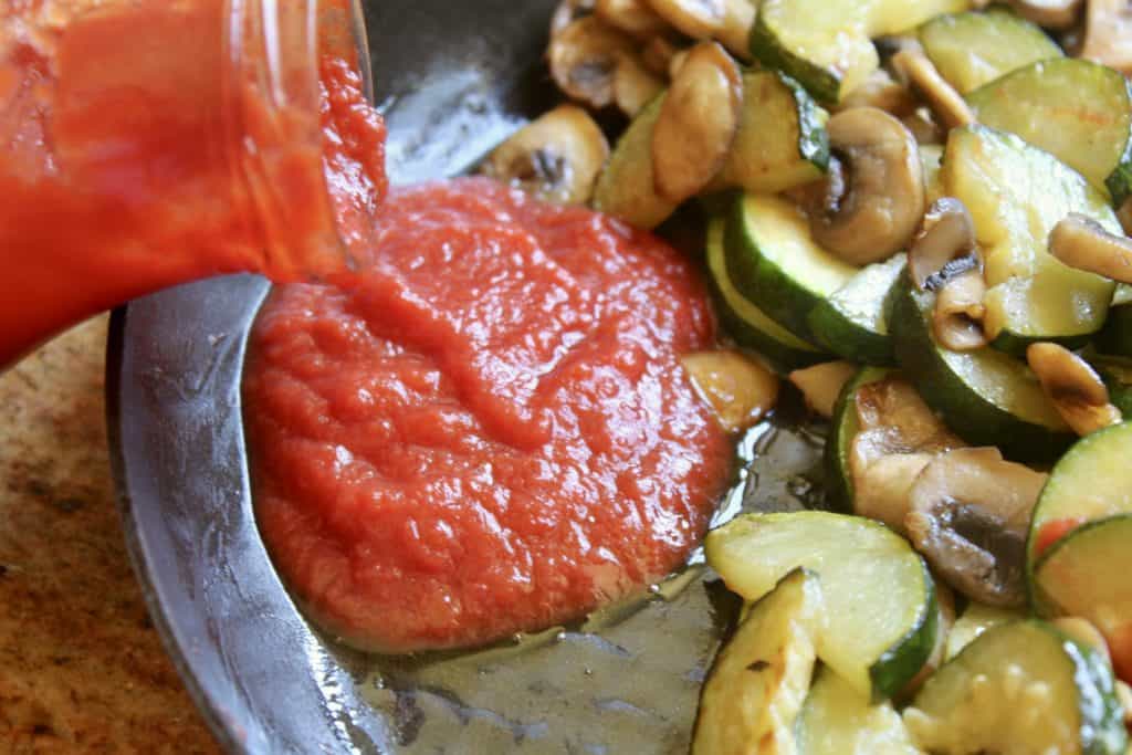 adding puree to zucchini and mushrooms