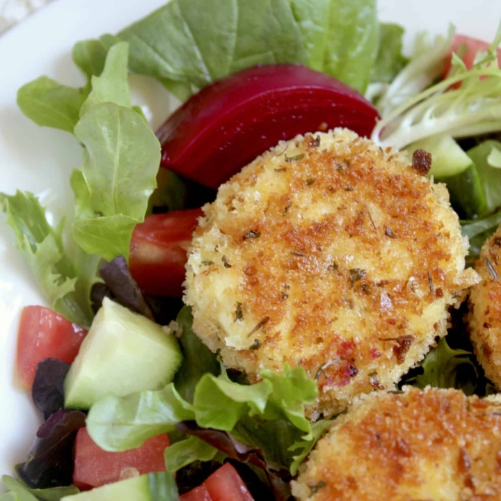 breaded goat cheese and beets on a salad