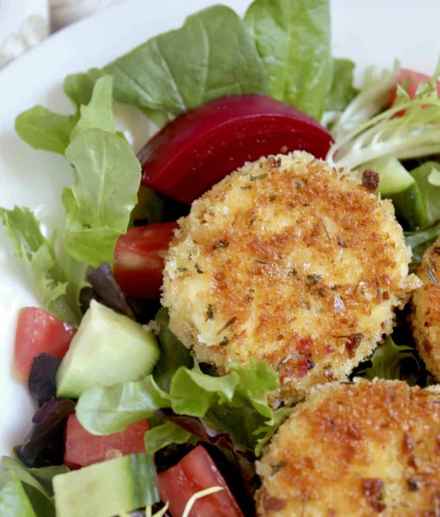 breaded goat cheese and beets on a salad