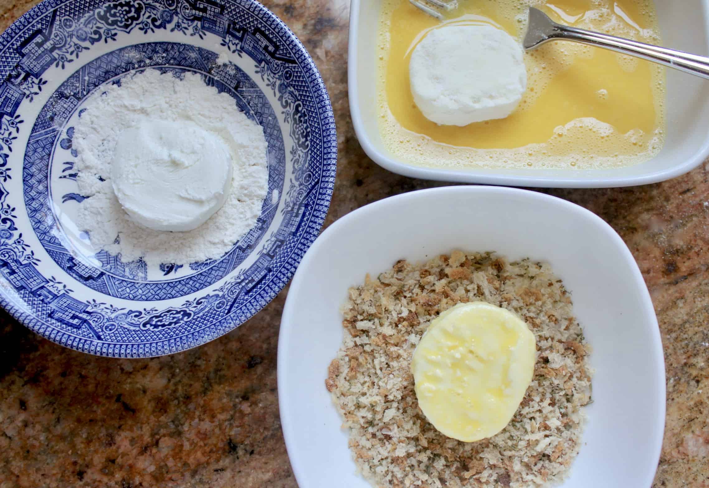 goat cheese in bowls of flour, egg and breadcrumbs