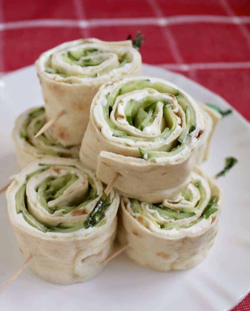 making cucumber and cream cheese sandwich rolls 