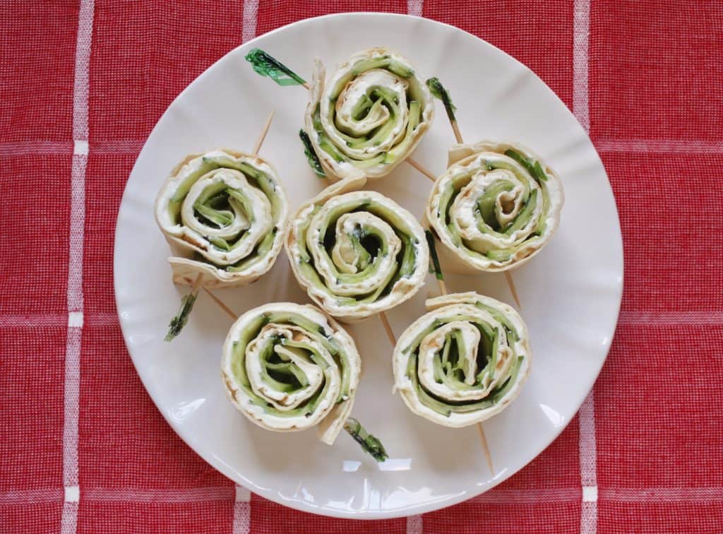 making cucumber and cream cheese sandwich rolls 