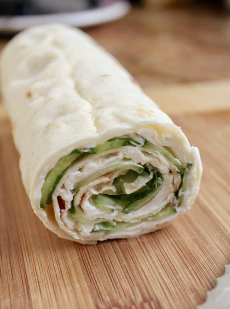 making cucumber and cream cheese sandwich rolls 