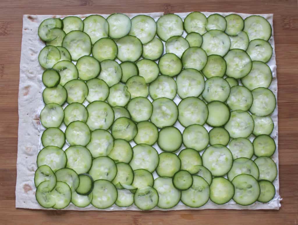 making cucumber and cream cheese sandwich rolls 