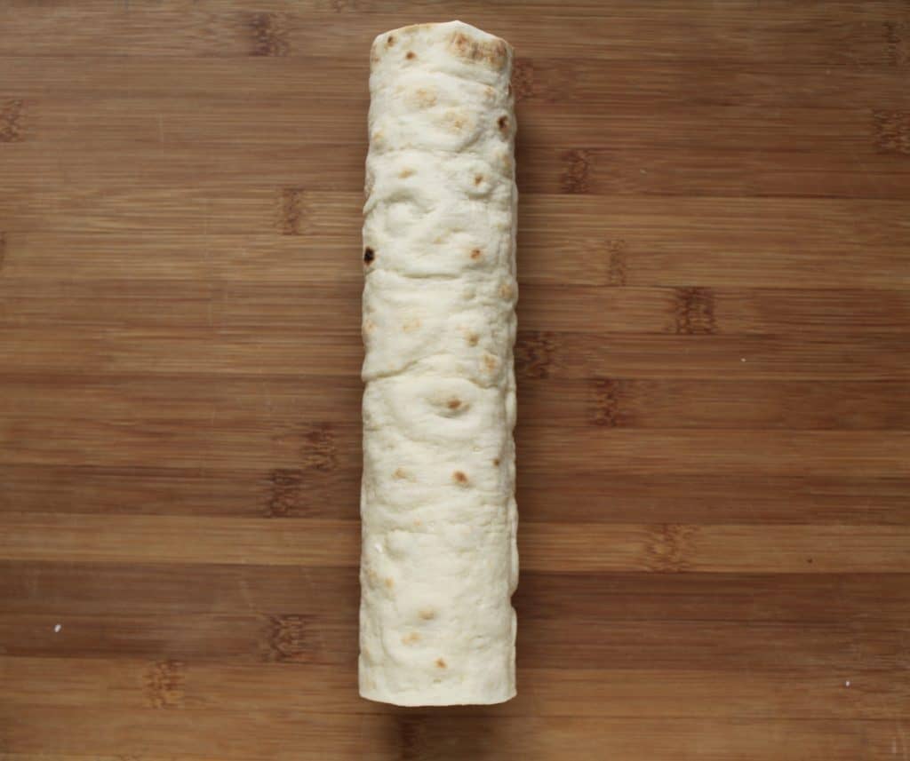 making cucumber and cream cheese sandwich rolls 