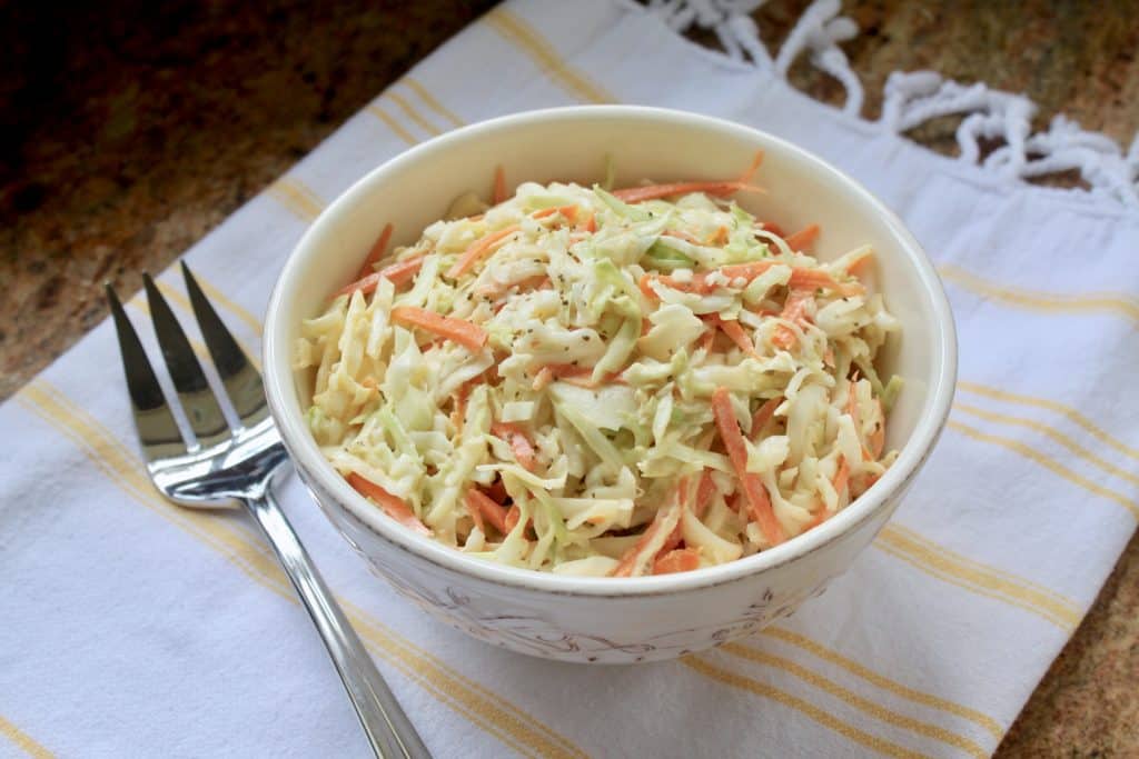 Spicy cole slaw in a bowl. Healthy sides for sandwiches.