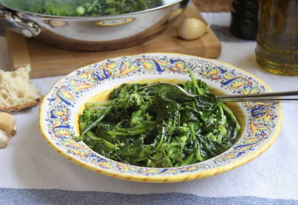 sauteed rapini in a bowl with bread