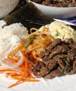 bulgogi on a plate with banchan