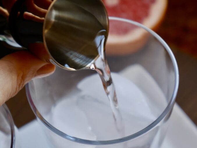 adding vodka to glass
