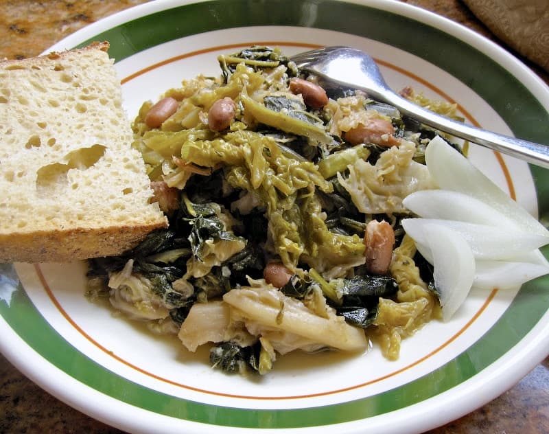 Minestra in a plate with sweet onion and slice of bread