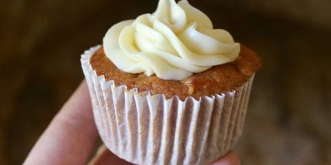 photo of hand with pumpkin carrot cupcake