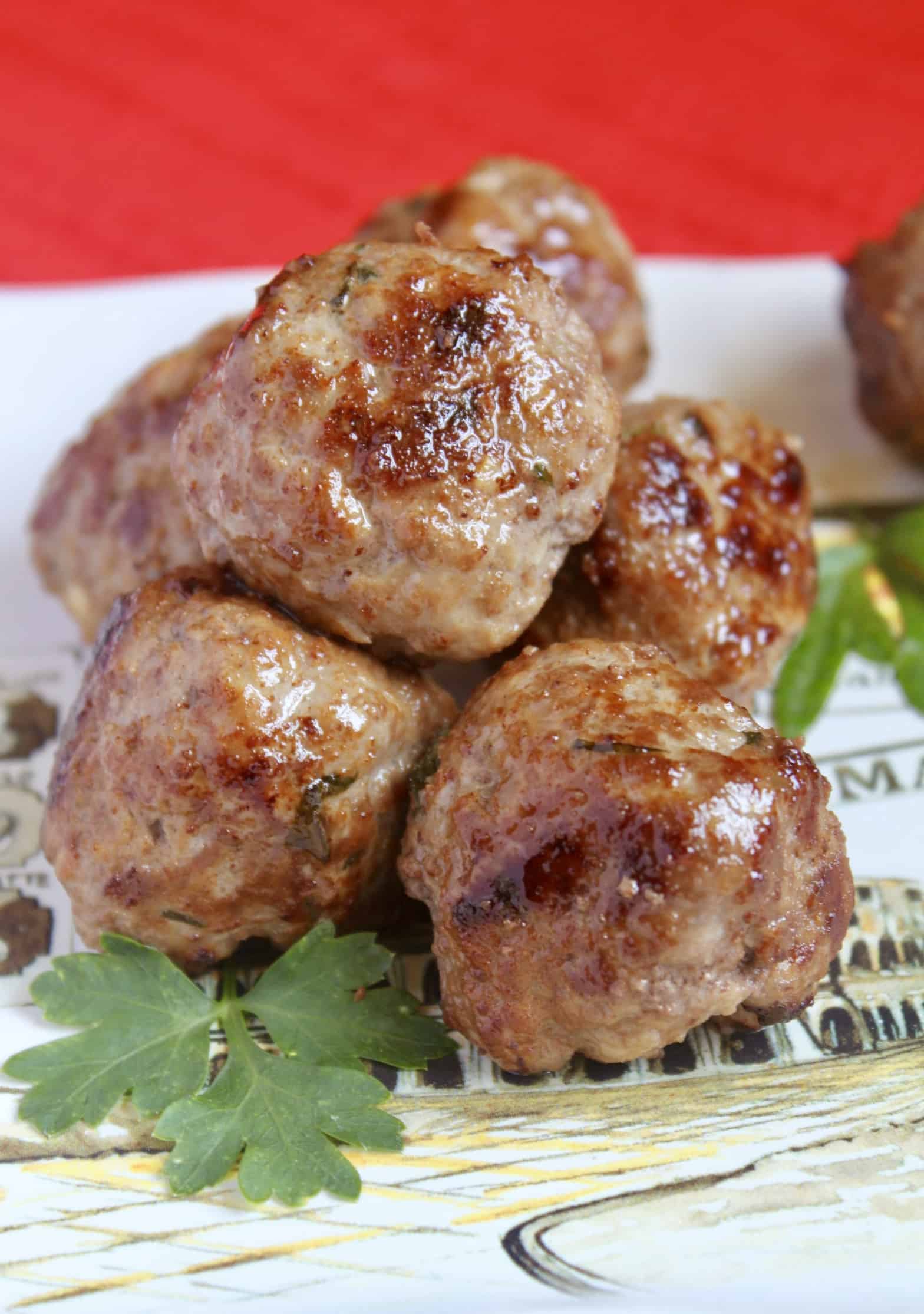 plate with meatballs and parsley on it