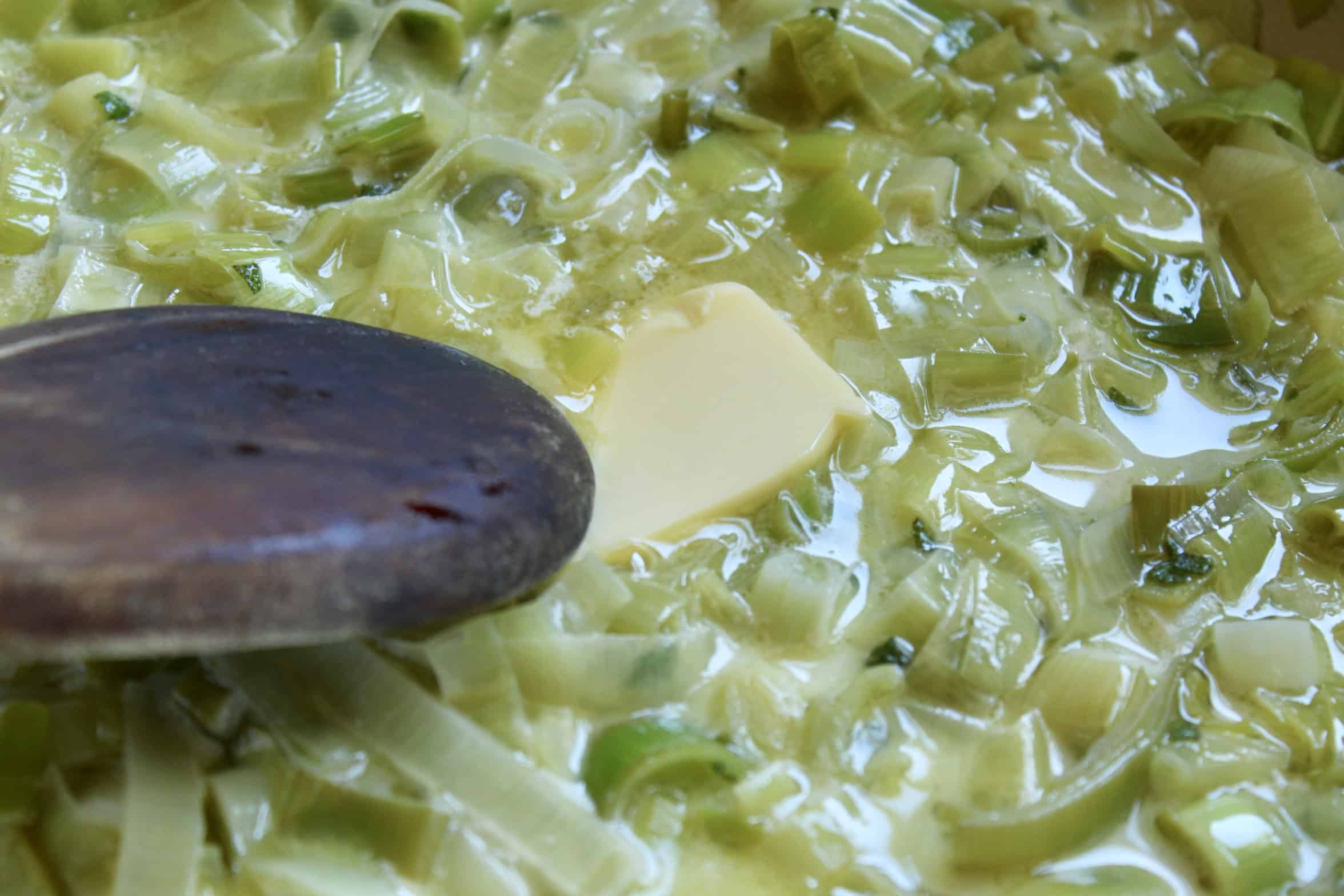 adding butter to leeks