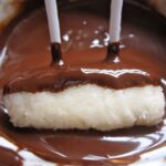 dipping coconut candy in chocolate