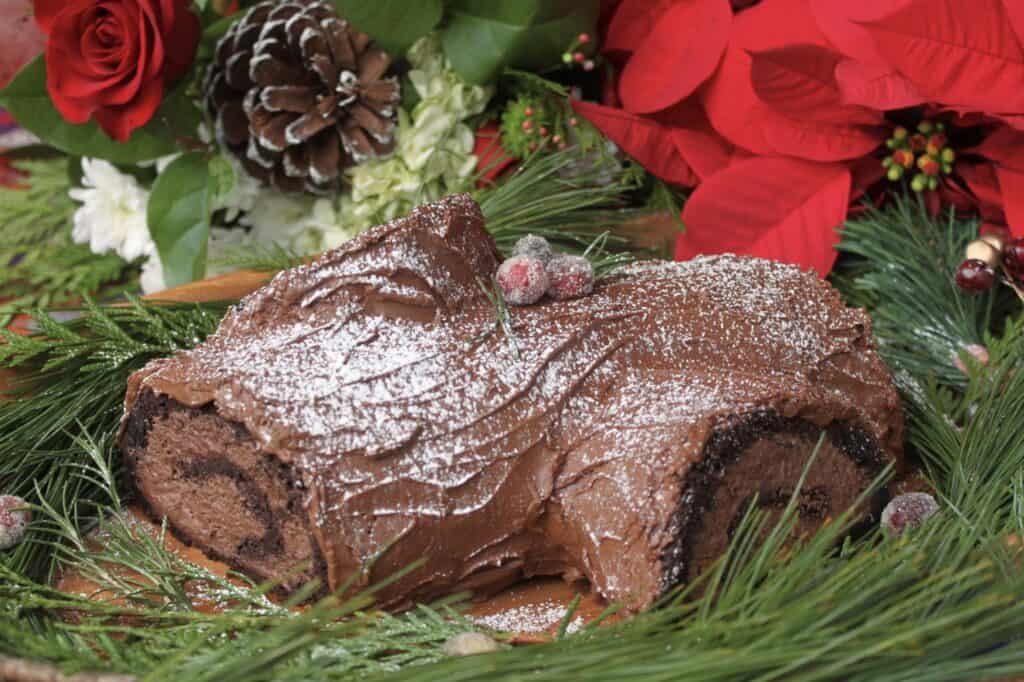 yule log with poinsettia and flowers