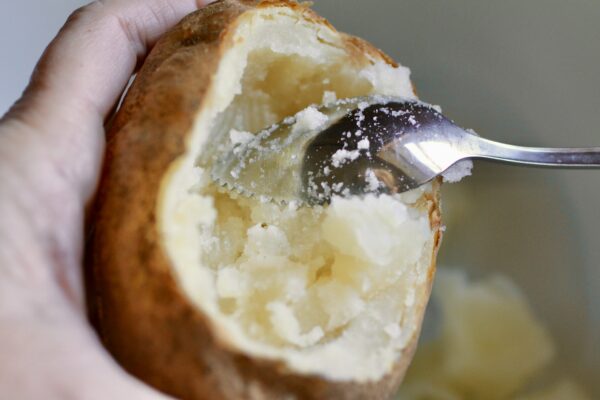 scooping out baked potato