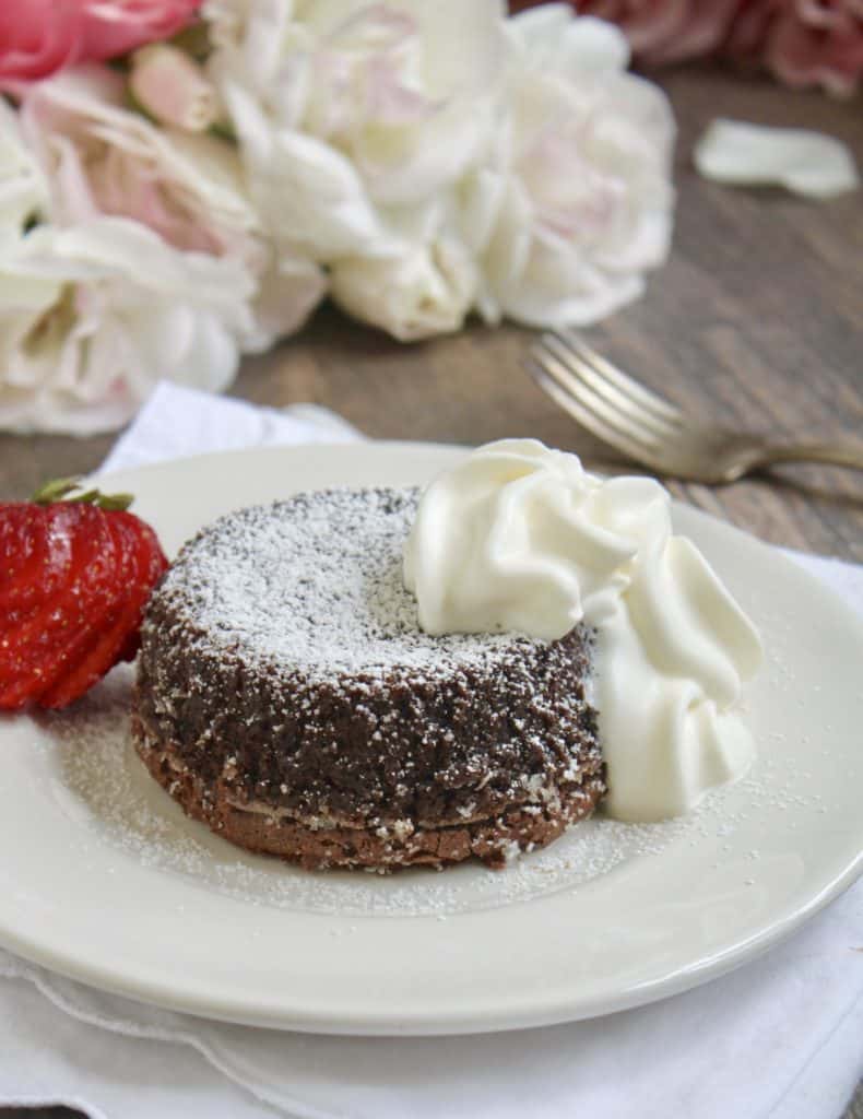 molten chocolate lava cake with cream and a strawberry
