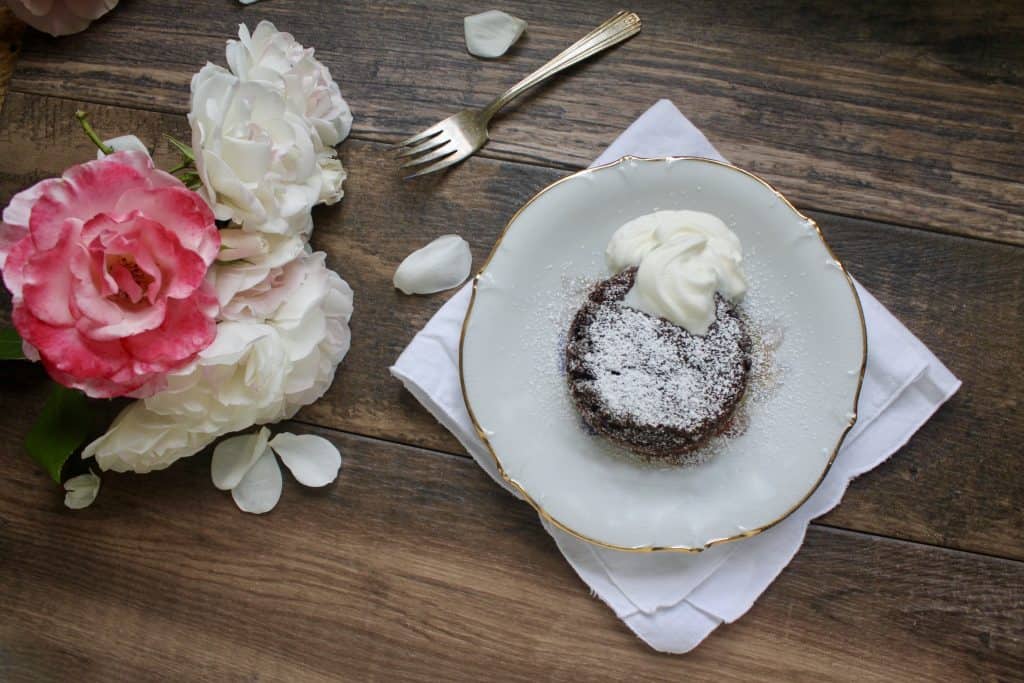 molten chocolate lava cake on a plate with cream
